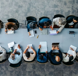 Long table with people working