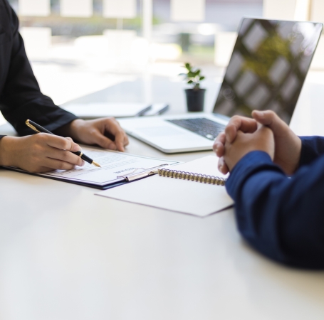 hiring manager reading a resume and pointing things out