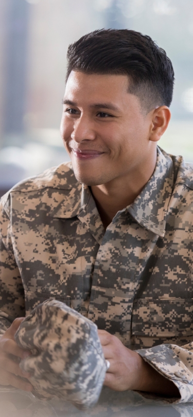 young man in uniform speaking with a woman