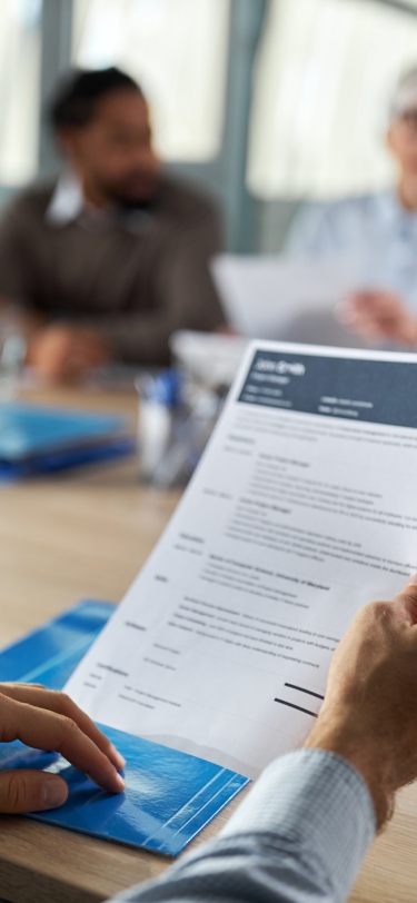 person holding a resume at a job interview